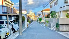 an empty street with cars parked on both sides