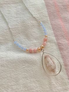 "Baby blue, gold, and rose pink beads paired with a silver wire wrapped Lettered Olive from Sanibel Island, Florida.  Necklace is 22.5\" long with lobster clasp, non tarnish Rhodium chain.  Thank you for visiting Planet Bloom! ✨" Gold Shell Necklace With Gemstone Beads As Gift, Pink Shell Necklace With Round Beads As Gift, Handmade Pink Shell Necklace, Adjustable Pink Beaded Shell Necklace, Gold Shell-shaped Beaded Necklace For Gift, Olive Shell, Sanibel Island Florida, Seashell Jewelry, Sanibel Island