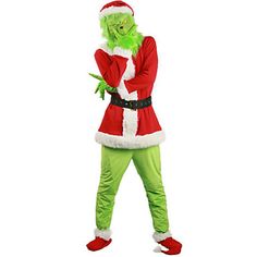 a man in a green and red costume standing with his hands on his hips while wearing a santa claus hat