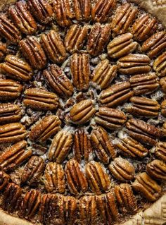 a pie with pecans in it sitting on top of a table