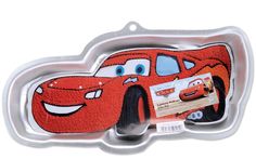 a red car shaped cake pan with an image of the character from cars on it