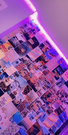 a wall covered in photos and neon lights