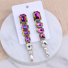 These stylish AB Colorful statement earrings are the perfect accessory for any event. Pageants, Prom, Bridal, Wedding Day, Mothers Day, Tv Show Earrings, On Stage Earrings, Gifts for her, Spring Must Have EarringsEarring Color: AB Colorful Diamonds, Purple, GreenEarring Length: 8 inches Earring Type: Pierced/ Post Back Diamonds Purple, Pageant Earrings, Prom Earrings, Crystal Dangle Earrings, Cubic Zirconia Jewelry, Earrings Elegant, Party Earrings, Red Earrings, Long Red