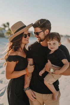 a man, woman and child are standing on the beach with their arms around each other