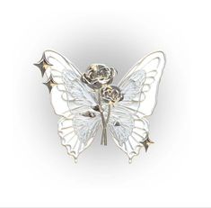 a brooch with a white butterfly and rose on it's back, sitting in front of a white background