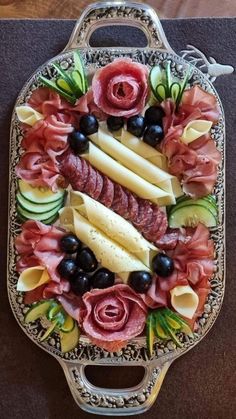 a platter filled with different types of meats and vegetables