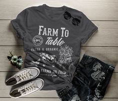 "Women's Vintage Farm To Table T-Shirt Farmers Cow Chicken Corn Farming Tee This vintage inspired t-shirt features cow, chicken and cornstalks and reads \"Farm to Table, no farms, no food, support local farming\". The small badge features a tractor and reads 'Farmers Feeding America'. Farms produce fresh, natural foods that you prepare for your family. Show support for locally grown produce and small farm raised meats and dairy products. This is a great tee to wear to the farmers market, on the Farmer Style Outfits Women, Corn Farming, Farming Shirts, Vinyl Sayings, Farm Shirts, Farm Quotes, Countryside Village, Farm Tees, Chicken Corn