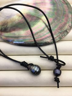 "NOTE: default length is 18 inches, if want other length,please leave me a note when order,thank you  Tahitian Pearl Leather Necklace, natural color Front pearl is tahitian pearl, size is 13-15mm--width,it's big back clasp pearl is freshwater pearl. Necklace is 9'' to 21''  long, intended to be worn as a necklace. Leather is 2 mm thick.  All tahitian leather bracelet  jewelry: https://www.etsy.com/hk-en/shop/WenPearls?ref=seller-platform-mcnav&search_query=Le10 All tahitian leather necklace jewe Adjustable Black Pearl Necklace With Pearl Charm, Adjustable Black Pearl Necklace With Charm, Adjustable Black Necklaces With Pearl Charm, Black Single Strand Tahitian Pearl Necklace, Black Tahitian Pearl Necklaces For Gifts, Black Single Strand Pearl Necklace As Gift, Black Tahitian Pearl Necklaces As Gift, Black Tahitian Pearl Single Strand Necklace, Black Tahitian Pearl Necklace For Gift