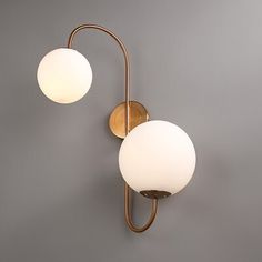 Add a soft and soothing glow to your living room, bedroom, and bathroom with this modern chic indoor wall lamp. Full of sculpturally minimalist and regal symmetry, this warmly elegant wall sconce is sure to add chic styling to your home decor. Manufactured from a sturdy metal construction and coated in an aged brass finish, it helps to provide you with reliable and durable service. Double white glass globes cap top and bottom, creating a lovely balance to the frame. Chic and effortless, this charming light fixture gives your contemporary or transitional decorating style a classy finishing touch. Corrigan Studio® | Corrigan Studio® Holten 2 - Light Modern Wall Sconce White Globe Glass Shade Wall Lamp in Aged Brass 22.4 H x 11.8 W x 7.9 D | 23.6" H X 16.1" W X 11.8" D | Wayfair Transitional Style Decor, Shade Wall, Glass Globes, Modern Wall Sconces, Decorating Style, Transitional Decor, Aged Brass, Modern Chic, Glass Globe