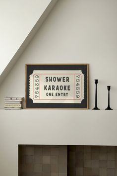 there is a sign above the fireplace in this living room that says, shower karaoke one entry