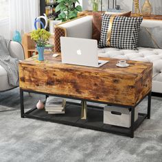 a living room filled with furniture and a laptop computer on top of a wooden table