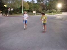 two young boys standing in the middle of an empty parking lot