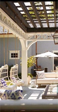 an outdoor living area with white furniture and blue walls