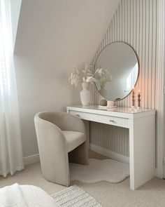 a bedroom with a vanity and mirror in it