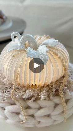 a white pumpkin sitting on top of a basket