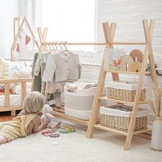 two children playing with toys on the floor in a room that has white walls and carpet