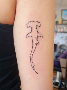 a woman's arm with a tattoo on it that has a dolphin drawn on it