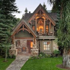 a large house with lots of windows in the front yard and trees on both sides