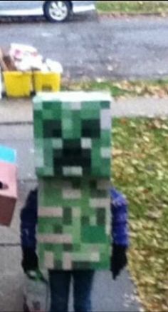 two people dressed up like minecrafts walking down the street