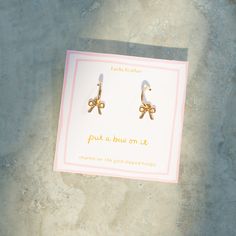 Add a touch of elegance and whimsy to your look with our Beautiful Bow Charm Hoop Earrings. These dainty hoops feature a delicate bow charm that gracefully dangles, making them a perfect accessory for any occasion. Treat yourself or surprise a loved one! Elegant Hoop Earrings With Dangling Charms For Gift, Elegant Hoop Earrings With Dangling Charms As Gift, Bracelet Tie, Bow Socks, Moon Accessories, Message Necklace, Gift Bow, Birthday Bracelet, Initial Earrings