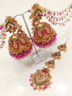 This beautiful piece of jewellery, the Laraib Jhumka Teeka with 3 Layers Sahare, is perfect for any special occasion. With its unique design featuring multicoloured natural stone beads, this Indian/Pakistani bridalwear partywear accessory is sure to catch everyone's eye. Crafted in India with excellent cut grade and multiple gemstones, this piece showcases the stunning beauty and intricate craftsmanship of Pakistani jewellery. It is an ideal gift for someone special on occasions like Engagement, Traditional Jhumkas For Eid Festival, Traditional Jhumkas For Eid Festivities, Traditional Jhumkas For Eid Celebration, Festive Bridal Sets With Latkans For Diwali, Festive Tilla Jhumkas For Navratri, Traditional Tilla Jhumkas For Eid, Festive Chandbali Bridal Sets For Eid, Chandbali Tikka With Zari Work For Festivals, Bollywood Bridal Sets With Latkans For Festive