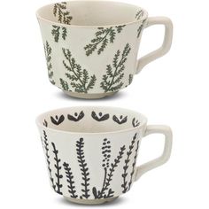 two white cups with black designs on them, one is empty and the other has green leaves