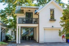 a white house with two stories and a garage