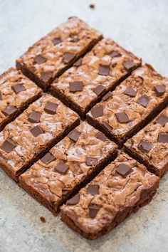 chocolate brownies cut into squares on top of a counter with one piece taken out