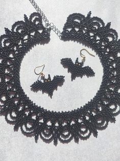 Add a spooky yet elegant touch to your Halloween outfit with this handmade beaded set featuring a detailed black choker and bat-shaped earrings. Crafted with intricate precision, this lightweight jewelry is perfect for celebrating the Halloween season. Whether you're attending a themed party or just want to embrace the eerie charm of the holiday, this set will add a bold, festive flair to your look. Dimensions: Earrings:  - Length: 3.5 cm (1.4 inches) - Width: 4 cm (1.6 inches) Choker: - Length: Black Spooky Jewelry For Costume Party, Black Beaded Jewelry For Halloween, Halloween Black Beaded Jewelry, Gothic Beaded Jewelry For Halloween, Halloween Beaded Black Jewelry, Gothic Beaded Choker For Festivals, Gothic Beaded Halloween Jewelry, Unique Black Halloween Necklace, Gothic Costume