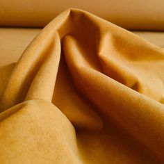 a yellow cloth is laying on top of a bed