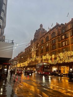 a city street is lit up with christmas lights