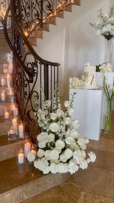 white flowers and candles are on the stairs