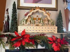 a mantle decorated for christmas with poinsettis and greenery