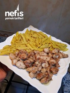 pasta and chicken on a white plate with the words nefis venek tarifier