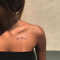 the back of a woman's shoulder with an inscription on it that says, you are