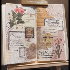 an open book with papers and flowers on it