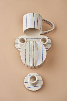 two white and blue ceramic objects sitting on top of a table