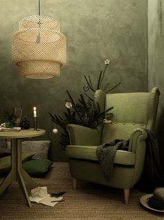 a living room with a green chair and table