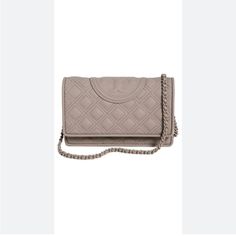 Questions? Leave A Comment Below! Take It Anywhere And Everywhere! The Tory Burch Fleming Matte Chain Wallet Is Sleek Enough To Carry With You All Day Long. The Beautiful Bag Has A Matte Design With Bolder Diamond Quilting. It Has A Magnetic Snap Closure With A Flap And A Braided Crossbody Tonal Chain Strap. Polyurethane Construction With Leather Trim. Zippered Interior Pocket. Six Interior Card Slots. Exterior Card Slot And A Bill Pocket. Signature Double "T" Patch On The Front. Tory Burch Crossbody Matte Bag, Grey Heron, Wallet On Chain, Chain Wallet, Tory Burch Bag, Wallet Chain, Beautiful Bags, Leather Trim, Chain Strap