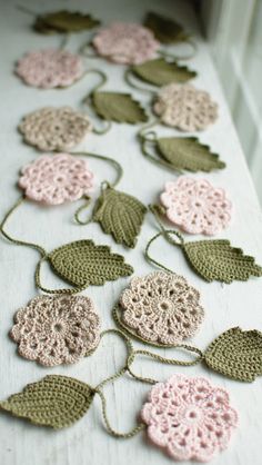 crocheted leaves and flowers are on the tablecloth, ready to be used as decorations