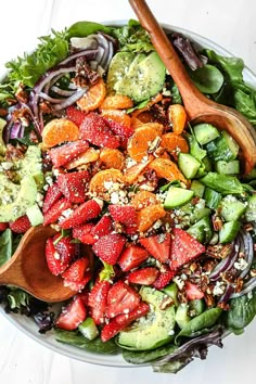 a salad with strawberries, cucumbers and other vegetables