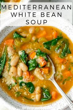 a bowl of white bean soup with spinach and carrots