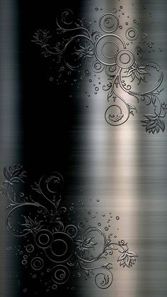 an abstract metal background with swirls and flowers on it's side, in black and silver