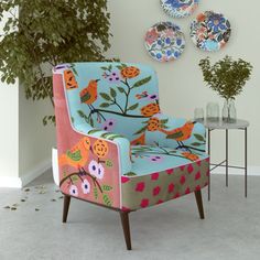 a colorful chair sitting in front of a wall with plates on it