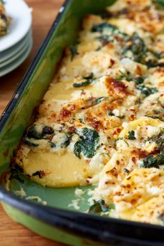 a casserole dish with spinach and cheese