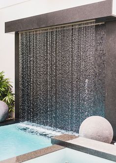 an outdoor shower head with water running down it