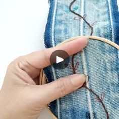 someone is stitching something on the jeans with their thumbnails to make it look like they're in love