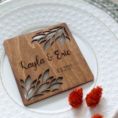 a personalized cutting board on top of a white plate with red flowers in the background