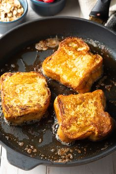 three pieces of toast cooking in a skillet