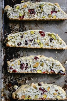 four slices of bread with cranberries and pistachios